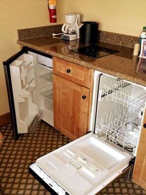A compact kitchen with a built-in coffee maker, a dishwasher, and a refrigerator with a freezer compartment. - NEW LISTING - 379-381 2-Bdrm Suite @ Base Area Mt. Crested Butte (Crested Butte)