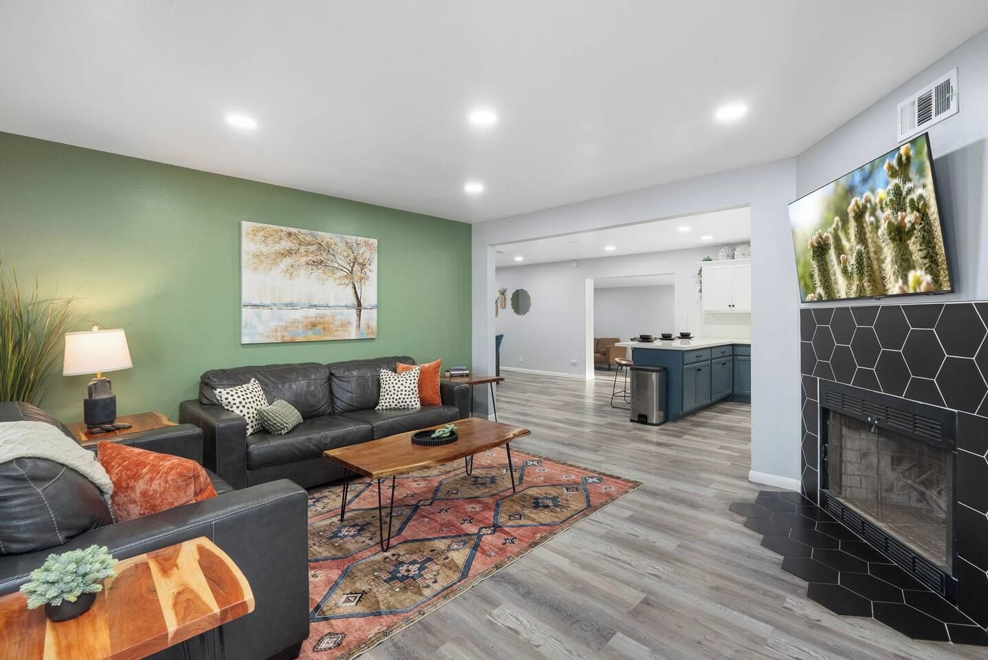 A modern living room with a sofa, coffee table, and a fireplace.