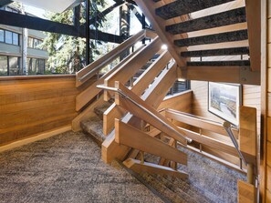 A wooden staircase with metal railings inside a building. - Ski Access, Bonus Room, Parking Garage, Hot Tub, and Prime Location! (Park City)