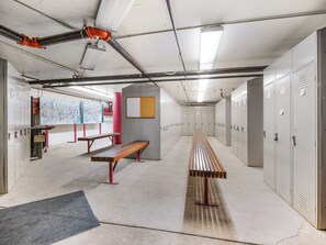 A corridor with lockers, benches, and a mural on the wall. - Ski Access, Bonus Room, Parking Garage, Hot Tub, and Prime Location! (Park City)