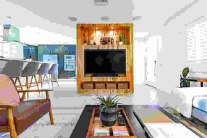 A living room with a TV, seating, and a coffee table. - ENSENADA - Modern, Family-Friendly, Private Pool, Golfer's Paradise (La Quinta)