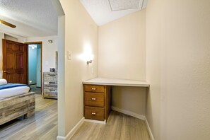 A bedroom with a wooden bed, a dresser, and a nightstand. - Pikes Peak Retreat | Hot Tub, Firepit + Pets (Colorado Springs)