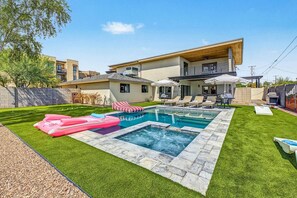 A residential property with a swimming pool, outdoor seating, and a covered patio area. - Casa Saguaro Old Town: 6BR Heated Pool Hot Tub (Scottsdale)