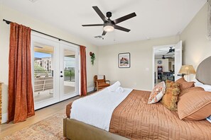 A bedroom with a bed, a ceiling fan, a sliding glass door, and a view of the outdoors. - Casa Saguaro Old Town: 6BR Heated Pool Hot Tub (Scottsdale)