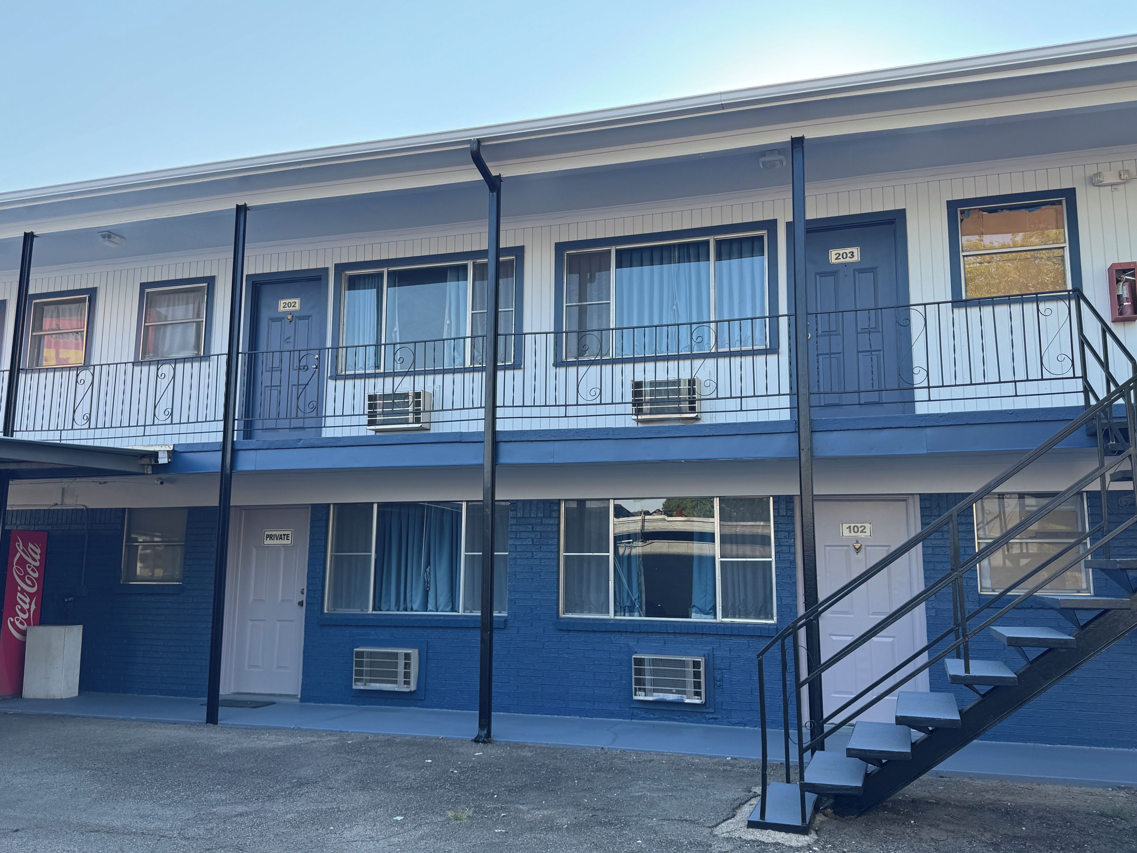 A two-story building with a staircase leading to the upper floor.