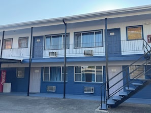 A two-story building with a staircase leading to the upper floor.