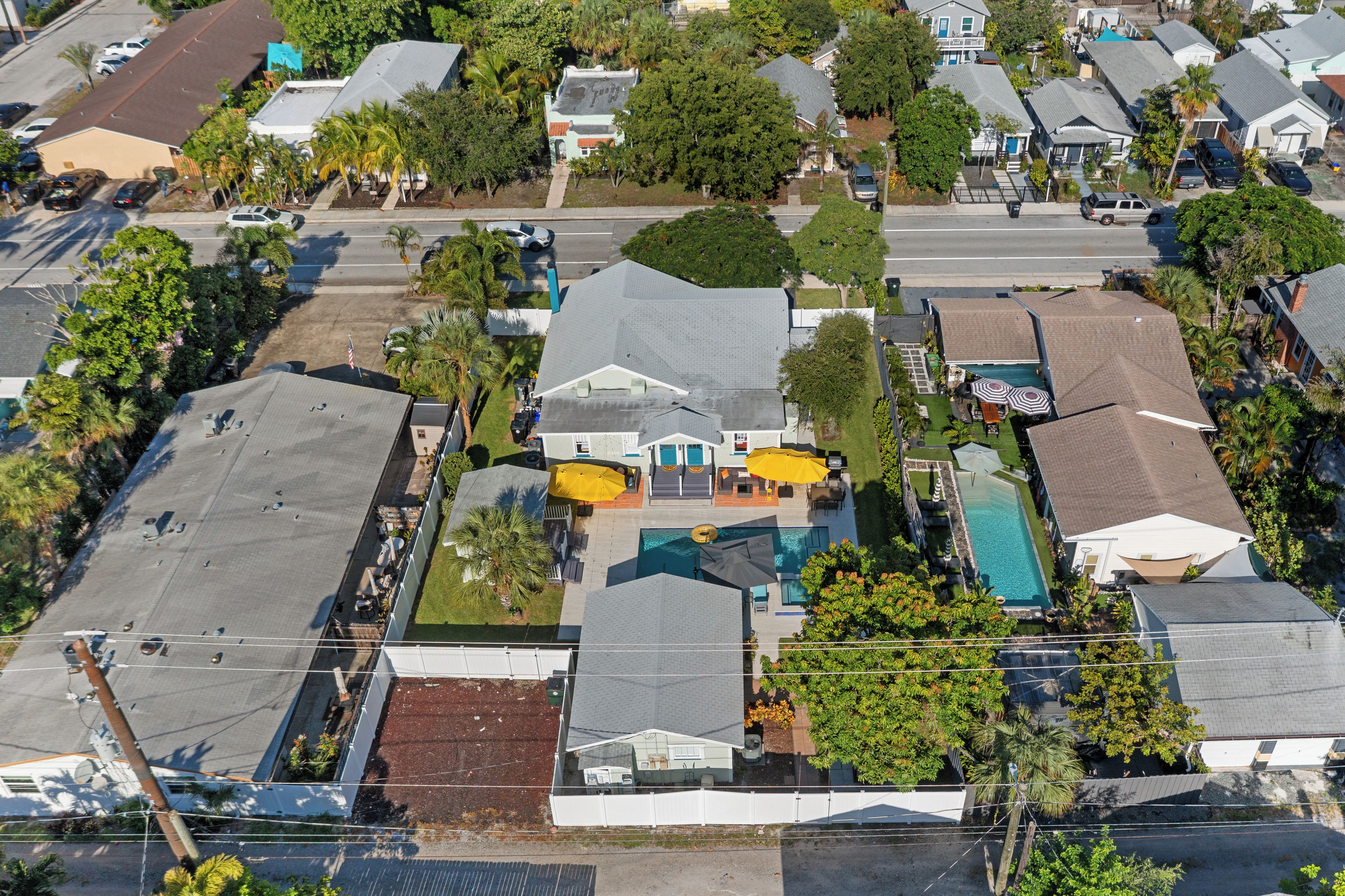 A residential area with houses, a swimming pool, and a street.