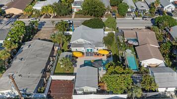 A residential area with houses, a swimming pool, and a street.