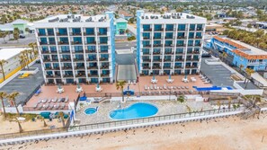 A hotel with multiple floors, a pool area, and a parking lot. - Ocean front condo in beautiful Ormond Beach at Tropic Sun Towers (Ormond Beach)