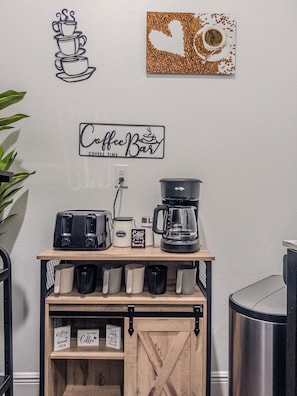 A coffee station with a coffee maker, a toaster, and a coffee grinder on a wooden shelf. - The Disney Oasis - Your Disney Day! - Your Spa Night! (Kissimmee)