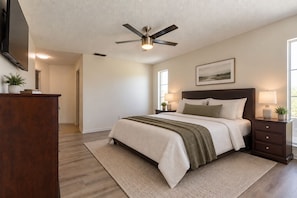 A bedroom with a bed, nightstands, a ceiling fan, a TV, and a window. - 4-Bedroom Lehigh Acres Getaway with Private Pool & Spa (Lehigh Acres)