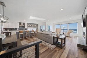 A modern living space with a kitchen, dining area, and seating area with a view. - Unforgettable Ocean Views From Home and Hot Tub, Fire Pit, Chef's Gourmet Kitchen, Steps From Beach (Rockaway Beach)
