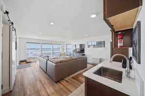 A modern kitchen with a built-in sink, a large island, and a view of the ocean. - Unforgettable Ocean Views From Home and Hot Tub, Fire Pit, Chef's Gourmet Kitchen, Steps From Beach (Rockaway Beach)