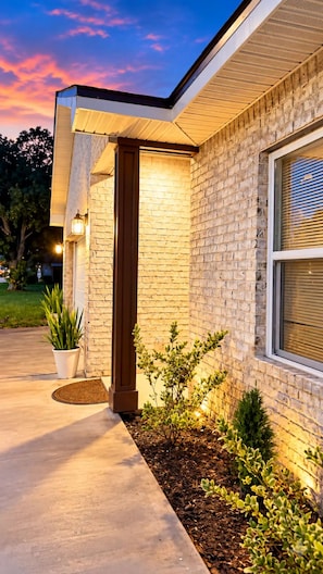 A modern house with a brick exterior, a wooden door, and a window with blinds. - 3-bedroom house in amazing Fort Walton Beach within 6 minutes from the beach. (Fort Walton Beach)