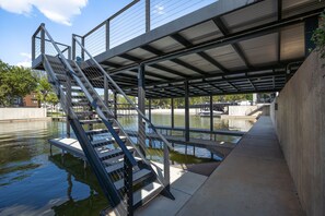 A bridge with metal railings and stairs leading over water. - 🌊 Palmilla at LBJ | Canal Front Pool, Boat Dock & Hill Country Lake Life 🚤 (Kingsland)