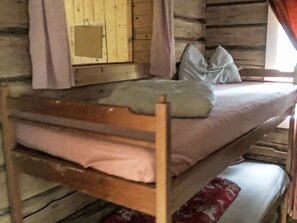 A wooden bunk bed with a pillow and a blanket. - in Arvidsjaur mit Terrasse by Interhome (Arvidsjaur)