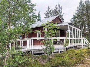 A rustic cabin with a wooden deck and a covered porch. - in Arvidsjaur mit Terrasse by Interhome (Arvidsjaur)