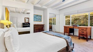 A bedroom with a bed, a desk, a piano, and a large window with a view of a fence and trees. - Windansea Bungalow by Avantstay Beach Cottage + Garden Patio Walk to Beach + Mins to La Jolla (La Jolla)