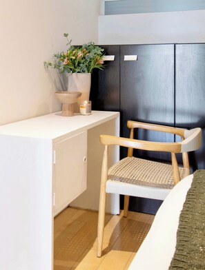 A room with a white desk, a wooden chair, a potted plant, and a black cabinet. - Beautiful apartment in the heart of Polanco (Mexico City)