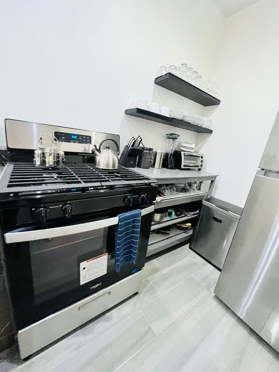 A modern kitchen with a stainless steel stove, oven, and dishwasher.