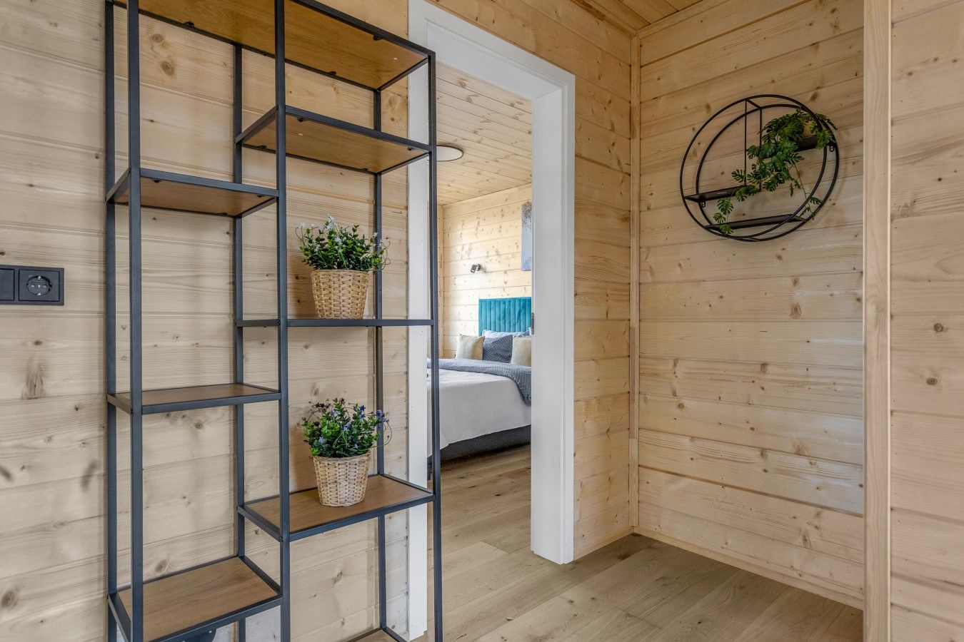 Hallway with plant shelving leading to a bedroom