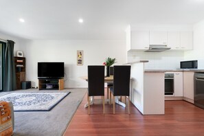 Enjoy the spacious open-plan living and dining area, thoughtfully arranged for relaxing, dining and spending quality time together. - 1BR with Pool and Large Balcony Near Manuka (Griffith)