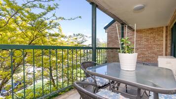 Enjoy your morning coffee or an evening drink on the balcony, with comfortable outdoor seating and lovely leafy views.