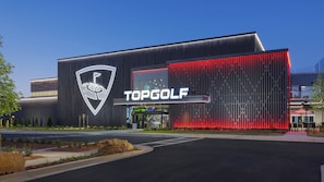 A modern building with a prominent logo and the name 'TOPGOLF' on the facade. - Spacious Family Retreat Near Stone Mountain Park and Lake Lanier Island (Snellville)