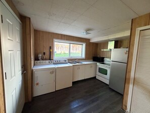 A compact kitchen with a stove, sink, and refrigerator. - Spacious 3 Bedroom, 2 Bathroom Basement Suite – Central Coquitlam (Coquitlam)