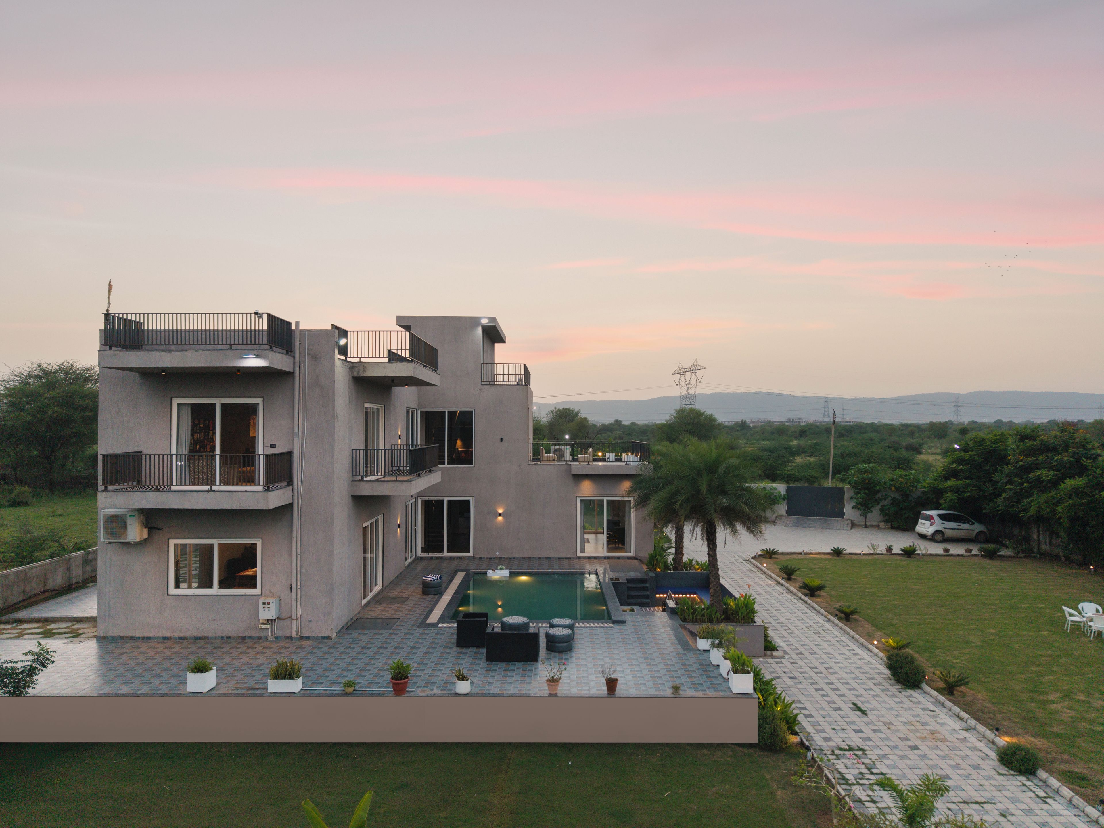 A multi-story building with a rooftop pool and outdoor seating area.