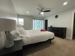 A bedroom with a bed, a dresser, a ceiling fan, and a window with curtains. - 3 Bedroom, sleeps 8, house centrally located in San Diego (San Diego)