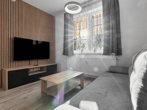 A modern living room with a flat-screen TV, a wooden accent wall, a window with curtains, a radiator, and a grey sofa. - George 05 by Interhome (Kovářská)