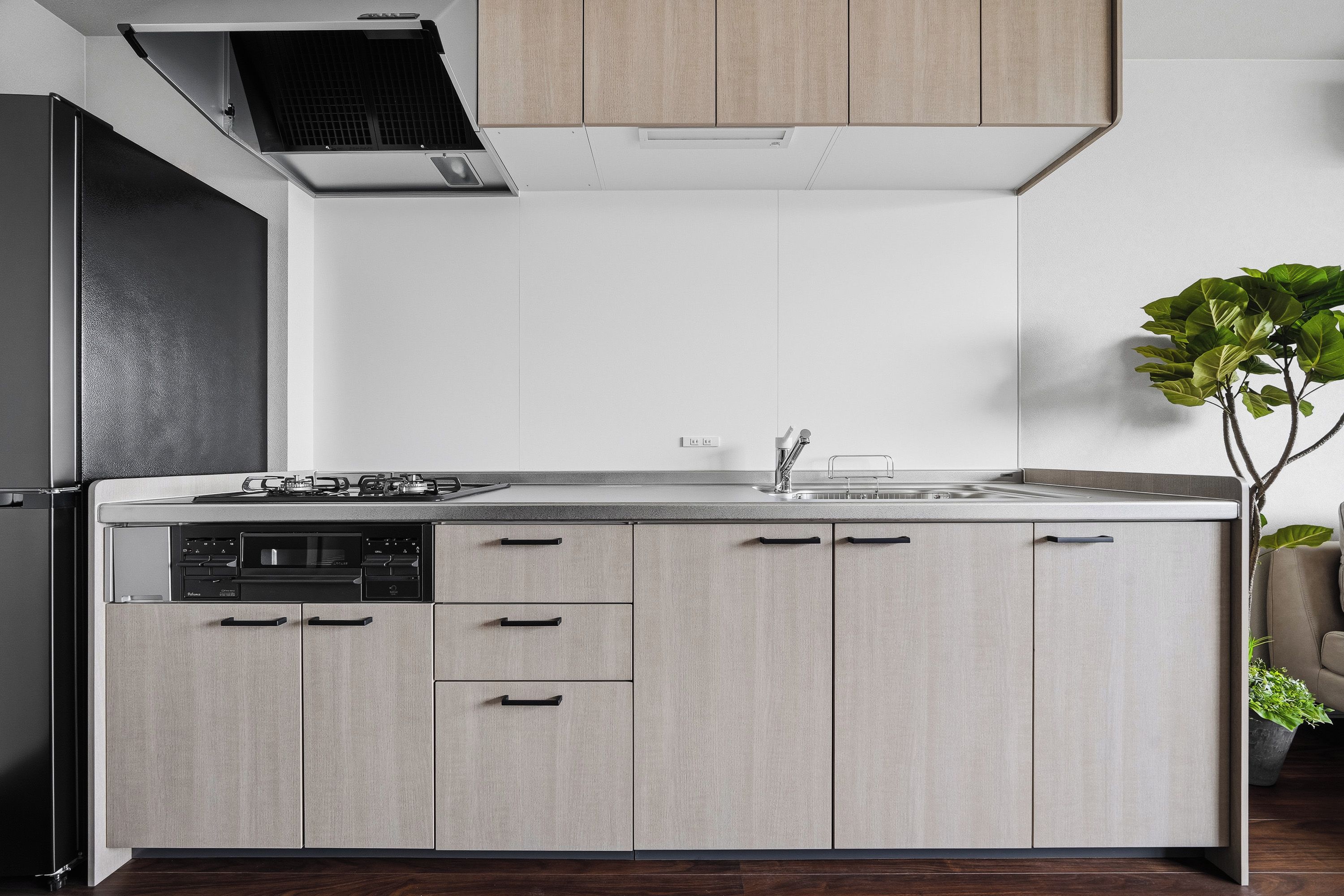 A modern kitchen with a built-in dishwasher, a gas stove, and a sink.