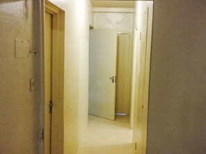 A hallway with a closed door at the end. - Apartment F24 by Interhome (Negril)
