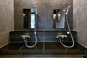 A bathroom with two sinks, each with a handheld showerhead, and a mirror above. - Hachimenzan Happo (Nakatsu)