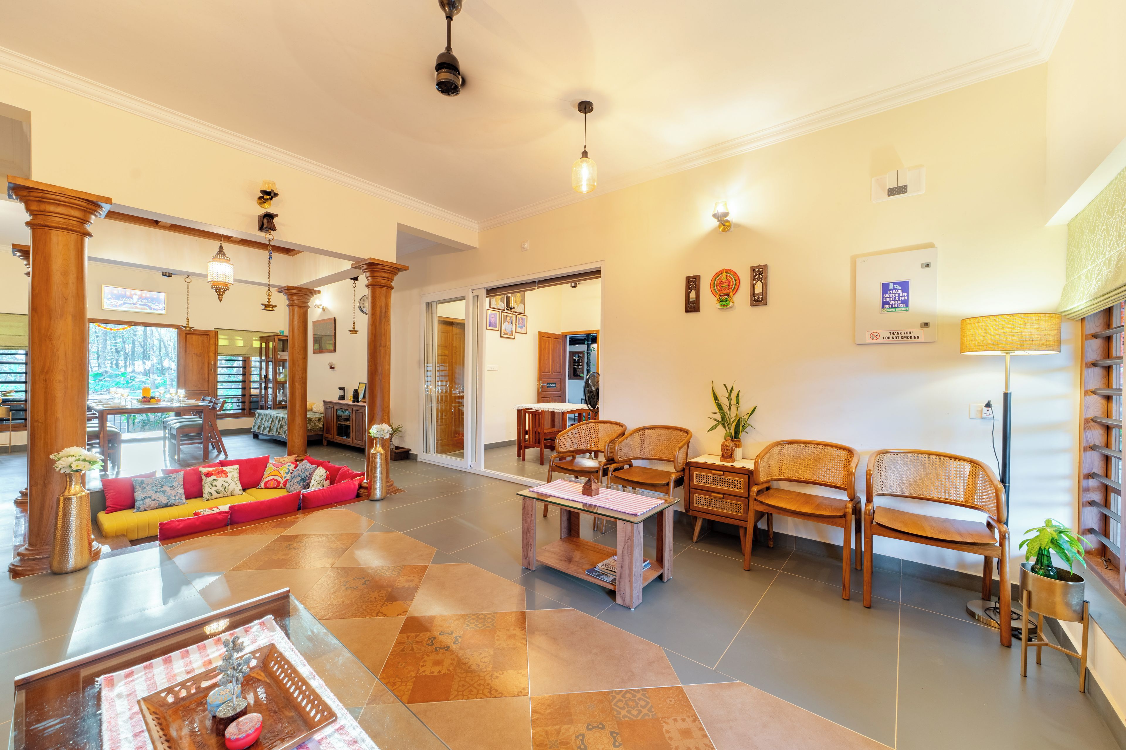 A spacious living area with a sofa, chairs, a coffee table, and a dining table.