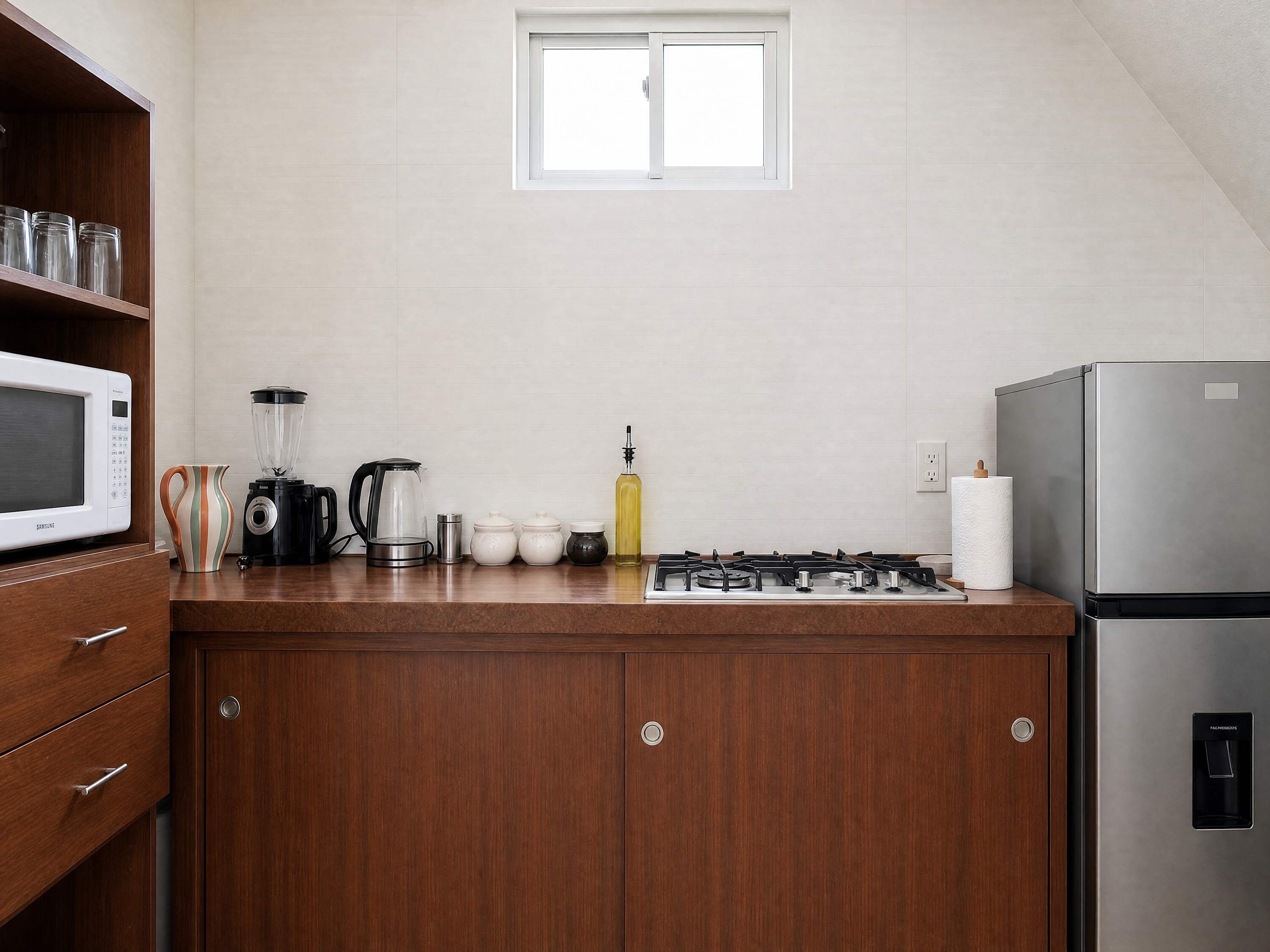 A kitchen with a microwave, stove, cabinets, and a window.