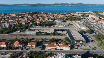 A coastal town with a marina, a large parking area, and a mix of residential and commercial buildings.