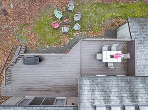 Aerial view showcases the retreat’s wooded setting, expansive roofline, and private surroundings. - Big Bass Lake • Shared Pool + Fire Pit + Game Room | Lake House Retreat (Big Bass Lake)
