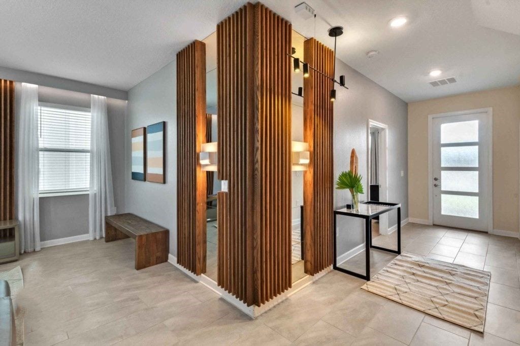 A modern interior with a wooden partition, a bench, a table with a plant, and a door with a view.
