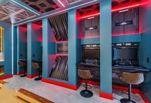 A room with Star Wars-themed decor, including a wall with a geometric pattern, a Star Wars logo, and a gaming setup with two monitors and a chair. - 9 Bed Home Storey Lake 9 Bedroom Home (Kissimmee)