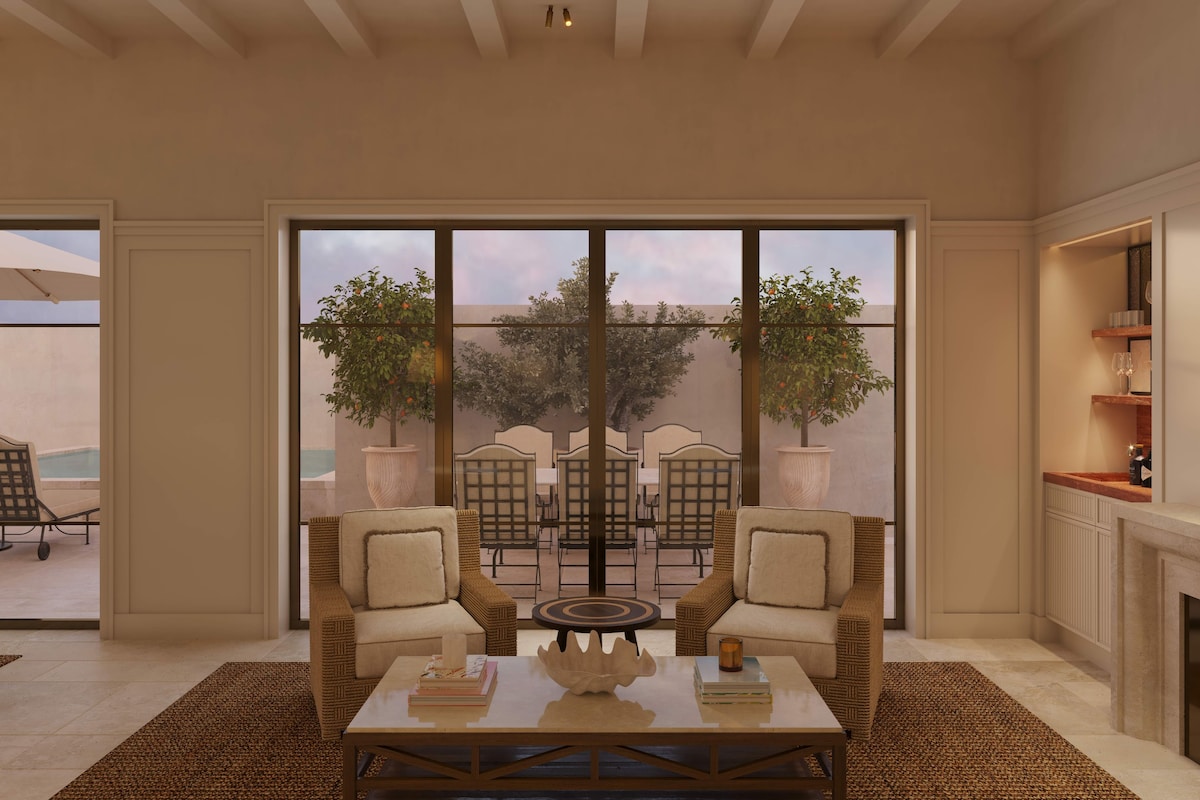 A spacious living room with a large sliding glass door leading to an outdoor patio area.