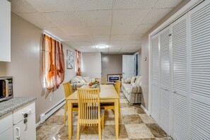 A compact living space with a kitchenette, dining area, and a seating area with a television. - Work, Play & Explore! Saugus Extended Stay (Saugus)