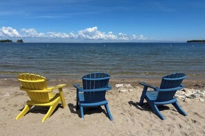 Three Adirondack chairs on a sandy beach with a calm sea and a clear sky in the background. - Great for Families! Egg Harbor Gem w/ Beach Access (Egg Harbor)