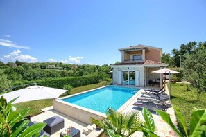 A two-story house with a swimming pool, outdoor furniture, and a garden. - Terracotta Hillside Hideaway Vranje (Vizinada)