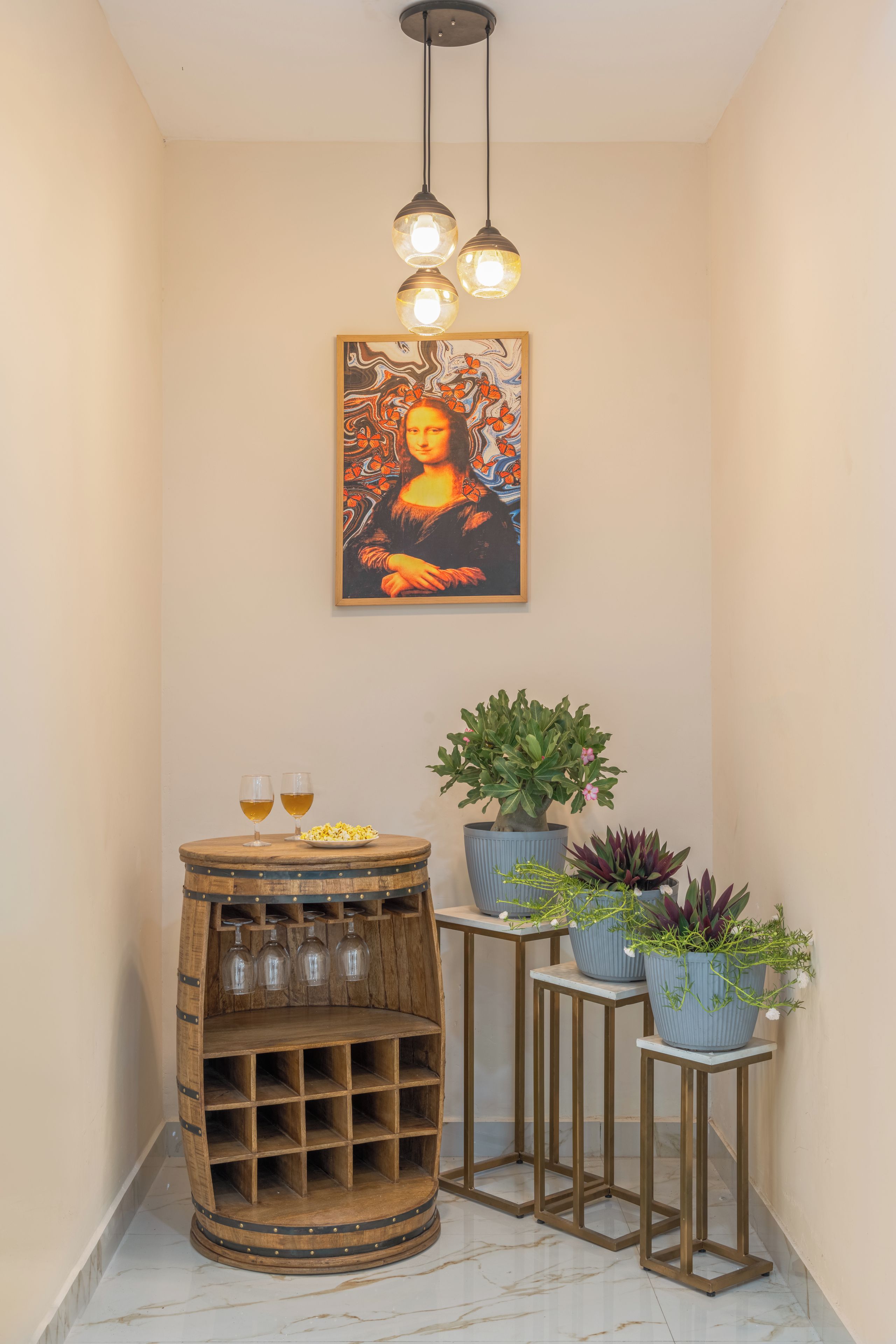 A hallway with a wooden barrel wine rack, two glasses of wine, a potted plant, and a framed artwork on the wall.