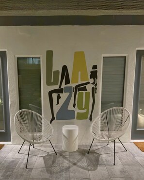 A playful art moment with café seating and bold design details throughout the courtyard. - Semi-Private Patio Facing Pool + Firepit | Mtn Views | Garden King at Mahala (Palm Springs)