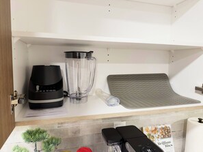 A kitchen with a coffee maker, a blender, and a waffle maker on the counter. - Private Suite Near Calgary Airport (Calgary)
