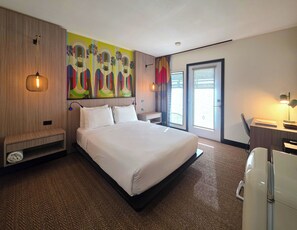 A hotel room with a large bed, a desk with a chair, a small seating area, and a large window with a view. - Pool + Spa + Firepit + Courtyard | Mtn Views | Sun Queen at Mahala (Palm Springs)
