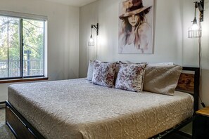 A bedroom with a large bed, a window, and a painting on the wall. - Hikes + Hot Tub Soaks! Extended Silverthorne Stay (Silverthorne)